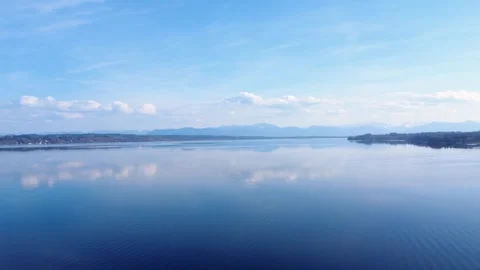 The camera shows a clear lake with water reflecting the sky.  Stock Footage 330793469