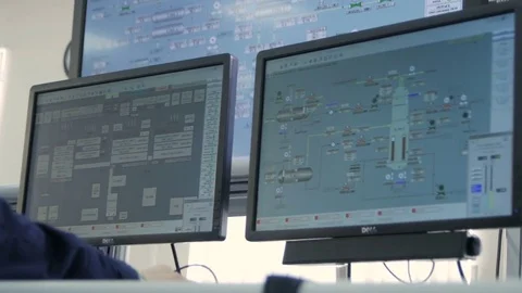 Camera Shows Monitors and Backside View Man at Computer Stock Footage 79030763