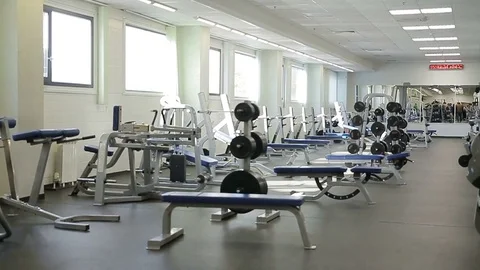 Camera Shows Spacious Light Empty Gym with Trainers Stock Footage 80536452