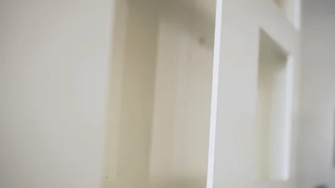 Camera shows white plastic frames of windows and doors in room. Stock Footage 99615032