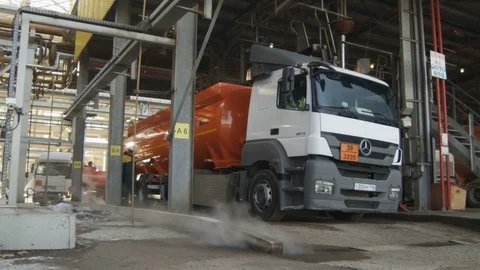 Camera Shows Worker Walking along Lorry with Oil Reservoir Stock Footage 79207374