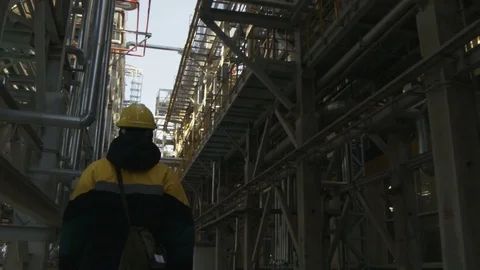Camera Shows Worker Walking among Oil Refinery System Stock Footage 79209298