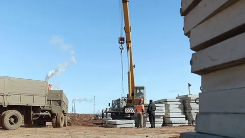 Camera Shows Yellow Crane Rotating against Blue Sky Stock Footage