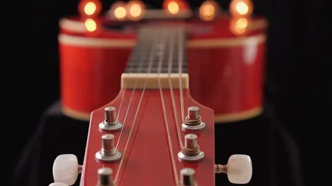 Camera slide along the neck of a red acoustic guitar 스톡 동영상 126021984