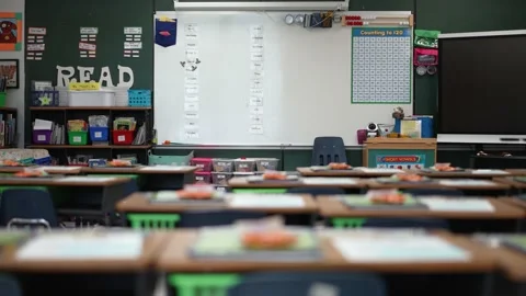 Camera slide to left showing empty school classroom with interactive whiteboard Video stock 159433184