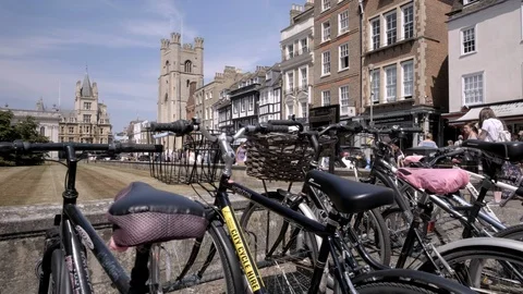 Camera slide over bike handlebars with Kings Parade Cambridge behind Stock Footage 99335286