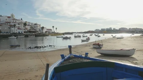 Camera slide over a blue boat in Ferragudo, Portugal Stock Footage 80118176