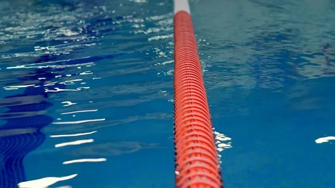 The camera on the slider rides along the edge of the pool Stock-Footage 99230656
