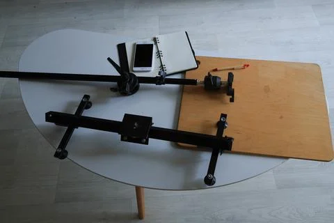 Camera slider setup with smartphone and notebook on a table Stock Photos