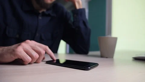 Camera slides around man's hands typing on smartphone. Businessman or freelancer Stock Footage 124215297