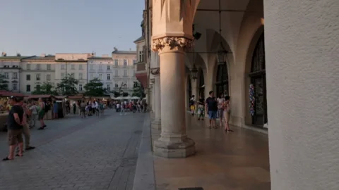 Camera slides from behind column to reveal Rynek Glowny Krakow Stock Footage 264049941