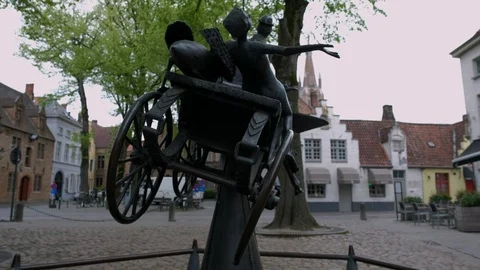 Camera slides from behind statue in Walplein Square in Bruges Stock Footage 90453317