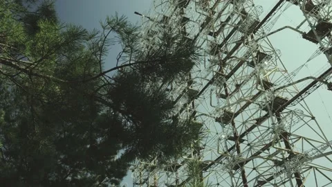 Camera slides from behind trees to reveal Duga-1 Stock Footage 143948745