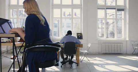 Camera slides left along trendy loft office, happy multiethnic business partners Stock Footage 108161319