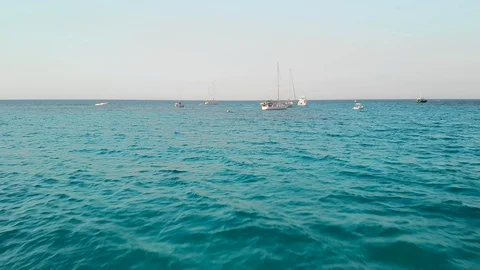 Camera slides over the open sea. Rises above the masts of sailing yachts and Video stock 116272339