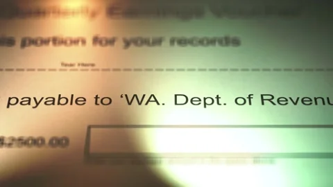 Camera Slides over Payment Voucher to the Washington Department of Revenue Stock Footage 267474181