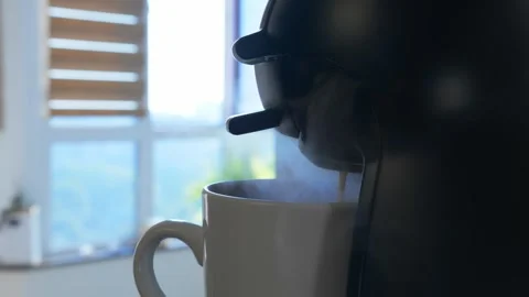 Camera slides past kitchen with small coffee machine brewing hot fresh coffee in Stock Footage 276832058