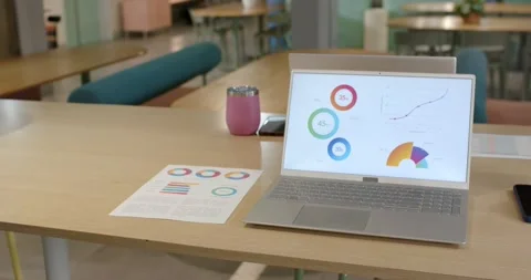 Camera is sliding forward and right, bringing open silver laptop closer on Stock Footage 336367985