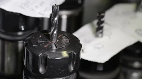 Camera sliding over CNC milling machine metal collets with changing light Stock Footage 48990668