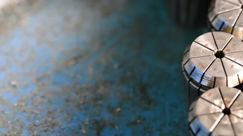 Camera sliding over CNC milling machine metal collets with changing light Stock Footage 49004894