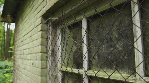 Camera sliding past old building with boarded up window Stock Footage 292528782