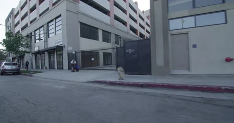 Camera slow motion passing by urban city buildings stores Stock Footage 139003934