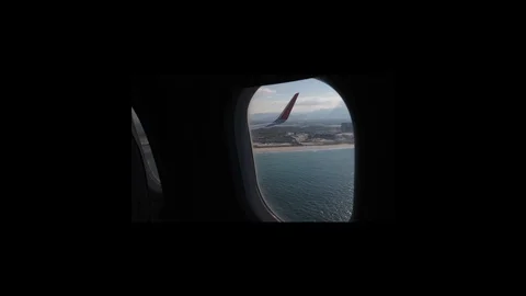 The camera slowly approaches the plane window showing a view of the clouds. 스톡 동영상 117440505