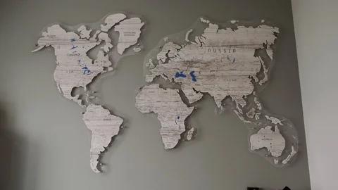 The camera slowly approaches the wall map of the world Stock Footage 128289573