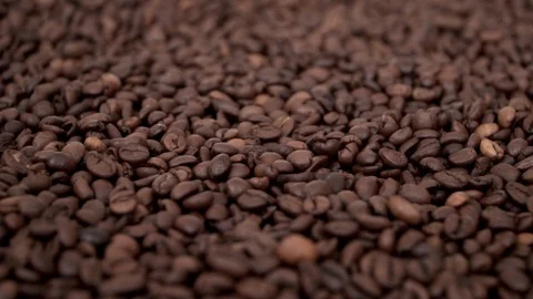 The camera slowly flies over the fragrant coffee grains lying in neat pile Stock Footage 103171659