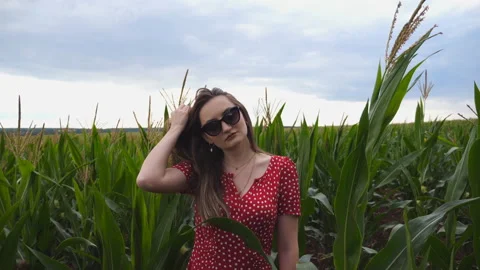 Camera slowly getting closer to beautiful young girl in red dress Stock Footage 135394652