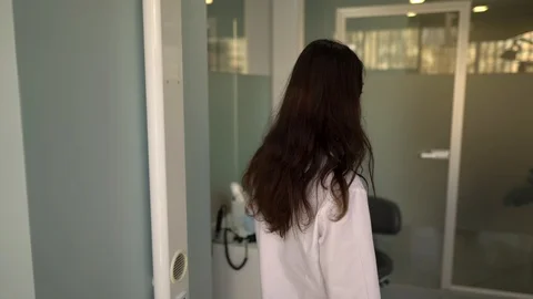 The camera slowly goes after a nurse in dentistry. She is approaching the Video stock 100368889