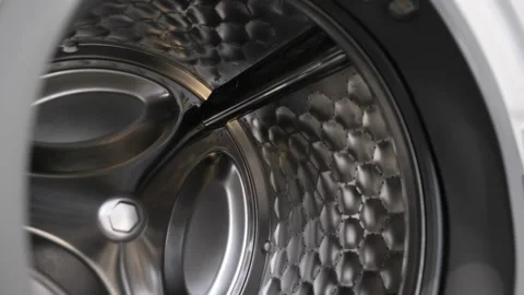 The camera slowly moves along the open washing machine and shows its interior Video stock 150703742