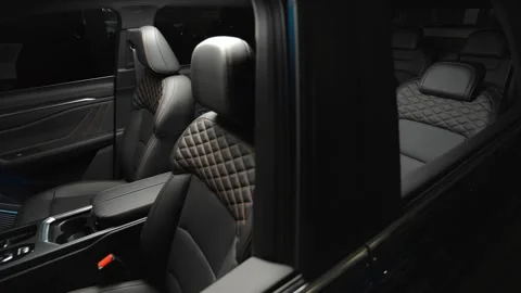 The camera slowly moves around the black interior of a premium car.  Stock Footage 272322063