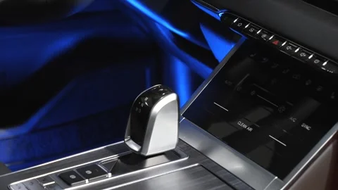 The camera slowly moves around the interior of a new car in a dark studio Stock Footage 280543367