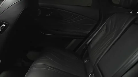 The camera slowly moves around the interior of a new car in a dark studio Stock Footage 280552693