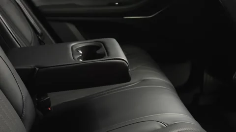 The camera slowly moves around the interior of a new car in a dark studio Stock Footage 280552725