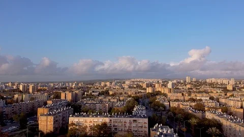 Camera slowly moves down to the residential buildings in Beer-Sheva at sunset Stock Footage 125891707