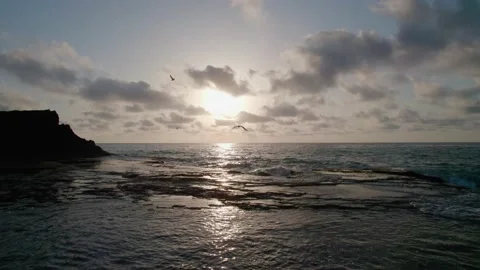 The camera slowly moves sideways, the waves crash against the rocks. Stock Footage 165765317