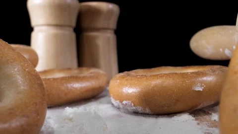 The camera slowly moves through the bagels that lie on the flour. macro plan Stock Footage 144907207