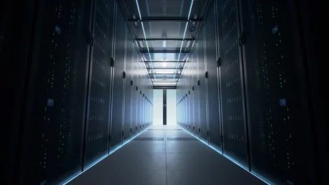 Camera slowly moving along the narrow corridor in data center with server. Stockbeeldmateriaal 107940045