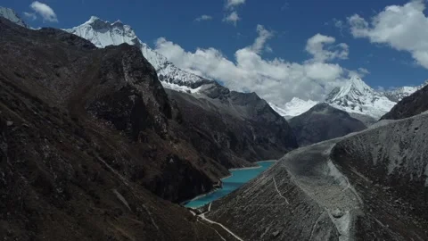 Camera slowly moving around a hill to reveal Laguna Paron with pale blue wat Video stock 252407532