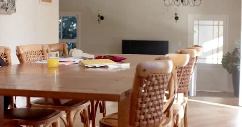 Camera is slowly moving forward and right across wooden table, revealing chair Stock Footage 337160246