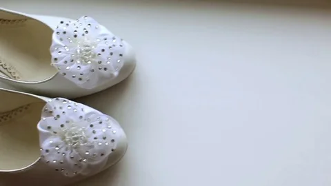 Camera slowly is moving to shoot a pair of classical beige woman's shoes.A Stockbeeldmateriaal 69212125