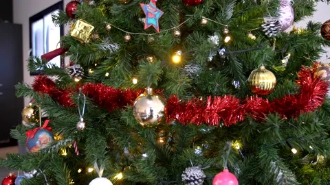Camera slowly panning through Christmas tree revealing decorations Stock Footage 140615463