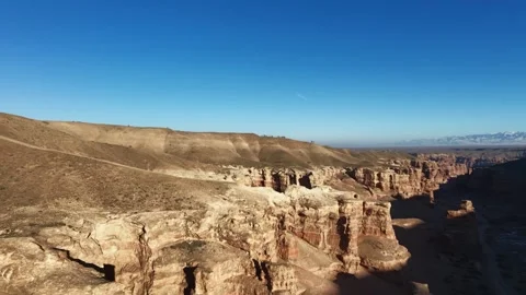 The camera slowly pans across the upper part of the Charyn Canyon, revealin.. Stock Footage 325960848