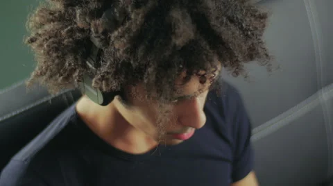 Camera slowly removes phone, and then the guy who listens to music in earphones Stock Footage 58587602