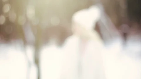 The camera slowly rolls to the young blonde girl in a white cap in the winter 库存影片 85242110