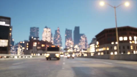 The camera slowly takes off between the lanes of the highway. Blurred city Stock Footage 267836897