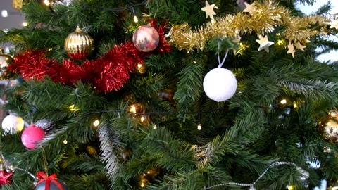 Camera smoothingly panning through Christmas tree revealing decorations Stock Footage 140618001