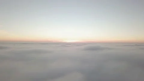 The camera smoothly descends into the clouds against the background of sunset Stock Footage 157157246